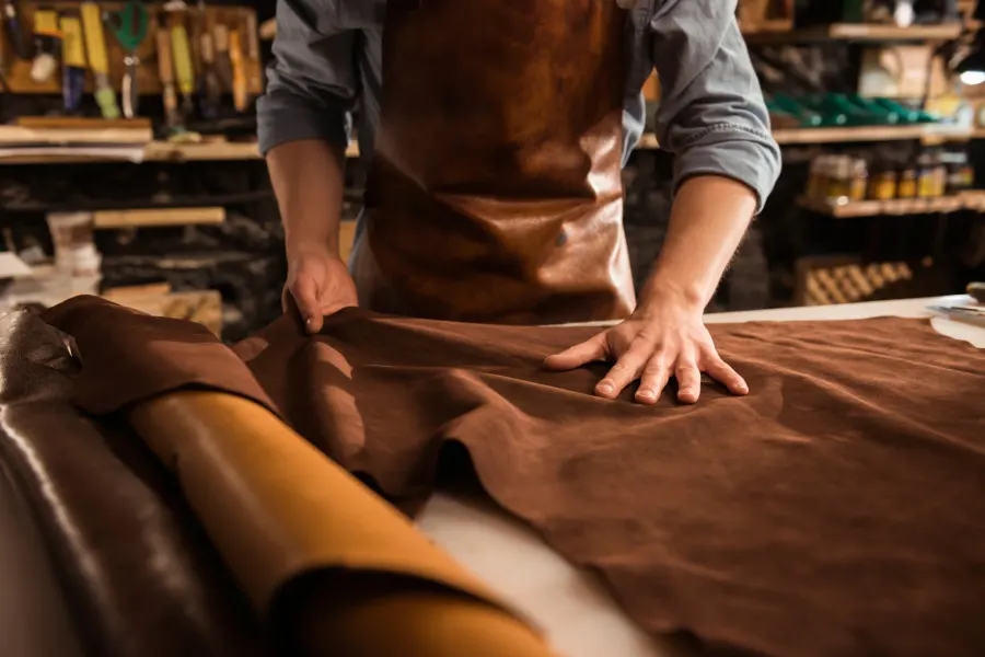 Artisan working a leather hide by hand